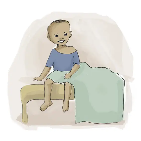 Sizwe sits on his bed. He is smiling.